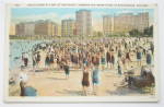 This vintage postcard is in very good condition. It features a Beach Scene At Foot Of Oak Street, Showing The Drake Hotel In Background, Chicago. This postcard measures approximately 5 1/2 x 3 1/2. Th...