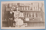 This picture postcard is from the Riverview Park in Chicago. It is in very good condition but is slightly yellowed. The front features 3 people taken in front of a Saloon backdrop. The reverse feature...
