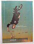 This fine ad is in near mint condition and measures approx. 8" x 11". This ad is suitable for framing. This ad depicts a man on a bike upside down and pouring chocolate milk into a glass.