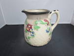 Pitcher Hand Painted Made in Japan. No chips, cracks or crazing. Appears to have a staining effect, but believed manufactured to have the appearance. Height 4 5/8 inch. Length handle to rim across 5 i...