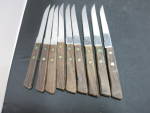 Vintage Stainless Steel Steak Knife set of 9 Made in Japan. This is a nice set marked Stainless Steel Made in Japan. Wooden handles with brass fittings. These were found at an estate with making tape ...