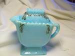 Westmoreland Blue Milk Glass Covered Creamer believed to be called Winter Glass. It has lovely molded designs accented with black paint. The crowned cover is so unusual to find with a lip on the end t...