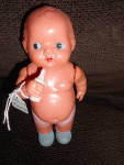 Occupied Japan Celluloid Baby doll with her bottle marked made in Occupied Japan. Very sweet 6 3/4 inch tall, strung, jointed doll holding bottle. Wearing a diaper and blue sock slippers. In excellent...