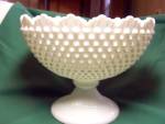 Fenton Hobnail Milk Glass Compote with a beautifully shaped rim and lovely pedestal base in an oblong shape. It is in wonderful condition and is embossed Fenton on the bottom. <BR>White Hobnail was ma...
