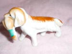 Irish setter dog figurine marked Japan. He is carrying a duck in his mouth. He is in wonderful condition and is 2 1/2 inches high, and 4 inches long.