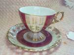 Cup and Saucer set elegant marked Made in Japan. It is a larger lovely set in a dark pink near maroon and white lusterware look set with wonderful gold patterns and trim lines with a lovely gold handl...
