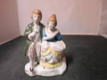 Vintage Occupied Japan Colonial Couple Figurine, hand painted. Lovely couple. The gent has some gold trim outlining down his front. Also some silver filigree around the bottom front. Stamped in red on...