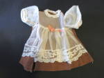 Antique Doll Dress with sheer overlay and sheer balloon sleeves with hand tatted lace trim. <BR><BR>A nice Brown cotton dress with ivory sheer overlay, white tatted lace trim and a pink satin ribbon. ...