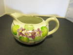 Floral Creamer marked made in Japan. Lovely with silver trim. Both transfer-ware and hand painted. Height 3 1/4 inch. Length spout to handle 6 inch. No chips no cracks no crazing. Marked Made in Japan...