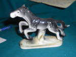 Occupied Japan Horse figurine marked Occupied Japan. This is a lovely black and cream colored horse in a great galloping position. She is a hard to find figure in a smaller size and is 3 3/4 inches hi...