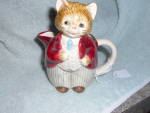 Otagiri Japan Cat  Creamer Pitcher marked Otagiri and was made in Japan. It has the nicely dressed cat on the front with his pants and jacket extending all around. It is 4 1/2 inches high and 4 1/4 in...