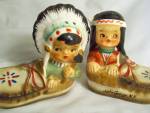 Indian Children Salt and Pepper Shakers Set labeled A Quality Product, Japan. It has the little Indian boy as the pepper and the little Indian girl as the salt. Both are sitting inside of a moccasin. ...