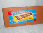 Xylophone in the original box marked MSK, Japan. It is in excellent condition and made of tin. It has the two music sticks plus a music sheet. This is rare to find with the box but the box does have s...