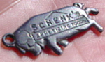 Offered is a very cute little Necklace Charm for Schenk's Appetizing Foods.  Not sure what kind of material it's made of but it's some kind of a metal.  Charm depicts a Hog/Pig and is marked on both s...
