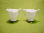 Offered is a Milk Glass Cream & Sugar Set w/Rose design on each side.  Bases of each have a brass ring trim.  Measure roughly 3 to 3 1/4 in. height.  Excellent condition with no damage.  These were ma...