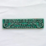 Great hand made tile advertising Renasissance Tile Manufacture. Scroll work and letters are molded in relief - green majolica glaze, white clay - measures 7" x 1 5/8".  Shallow chip on right...