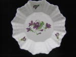 This lovely little pin dish was produced by Shelley China in floral violets motif.  The dish measures 4 12" wide and 7/8" high.  It is free of any chips, cracks or discolorations.