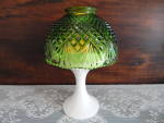 This example of candle mini lamp made by Westmoreland in the 1970's features a green faceted pineapple and fan shade on a milk glass base.  The base is signed with the Westmoreland mark.  The lamp mea...