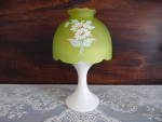 This charming example of Westmoreland's candle mini lamp features a frosted green shade with painted daisies on a milk glass base.  The base has the westmoreland mark and measures 7 1/2" high and...