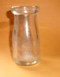EMBOSSED JEWETT`S DAIRY WATERTOWN NEW YORK ONE CILL (???) LIQUID MILK BOTTLE REGISTERED. MEASURES  4 1/4H X 2 1/8W INCHES AT THEIR LONGEST POINTS. HAS TINY AIR BUBBLES AND & FINE SCRATCHES. NO CRACKS....