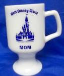 Vintage Collectible Glassware<BR>Walt Disney World Mom logo<BR>white milk glass pedestal mug<BR>Features wording and image in blue on only one side of the mug.<BR>Measures approx. 5 1/2" tall, 3&...
