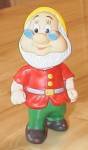 Neat collectible Disneyana toy, a plastic squeeze toy of Doc, one of the seven dwarfs from the movie Snow White and the Seven Dwarfs. At the bottom back of his coat or jacket in impressed letters over...