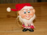 Nifty find out of a home.  This is a vintage figural Christmas tree hanging ornament which is meant to portray either one of Santa's elves or Santa Claus himself, we are not sure.  Body is formed from...