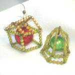 A pair of vintage Japan wire beaded dimensional Christmas ornaments in the shape of a house and a bell. The house is about 1-3/4 inches diameter. Tiny mercury glass gold and chartreuse beads form the ...