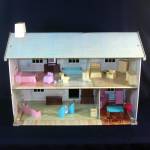 A vintage large size 2 story, five room tin litho dollhouse with most of the original furniture. This was the Wolverine Rosewood Manor doll house, marketed under their Today's Kids line from the 1980s...