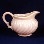This attractive swirl creamer is in the Franciscan Coronado pattern by Gladding McBean. The color is coral, the finish is matte. The circular Franciscan Ware backstamp was in use from 1940 to 1947. In...