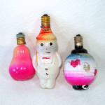 Three vintage Japan C6 type figural Christmas light bulbs from Japan: a snowman, a pear, and an Oriental lantern. The 3 inch snowman is painted on clear glass which dates it to the 1920s or early 1930...