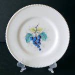 This 1940s -1950s Beaded Edge milk glass dinner plate by Westmoreland Glass Company is decorated with a blue grape cluster, teal and pale chartreuse leaves, and faint gray shadowing. There were eight ...
