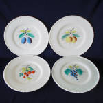 A set of four dinner plates in the 1940s -1950s milk glass Beaded Edge line by Westmoreland Glass Company. There were eight different fruit decorations in the line, as well as flowers and birds. Inclu...