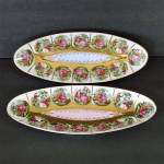 This pair of porcelain ceramic oval relish or celery dishes features Fragonard style romantic courting couple scenes outlined in 22k gold trim, one with a pink center, the other blue. They were made i...