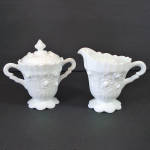 This Fenton footed creamer and covered sugar set is in the Rose pattern, produced in white milk glass from 1967 to 1974. Some collectors call this pattern Cabbage Rose. It's quite ornate with scallops...