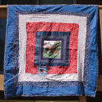 This vintage machine pieced quilt was made from strips of salvaged denim jeans, blue cotton chambray shirting, red and blue bandana print cotton, and two different red, blue, and white cotton print fa...