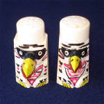 A pair of unusual figural novelty salt and pepper shakers from 1930s Japan, made of hand painted carved bone. They're in the form of eagle totem poles. The 2 inch shakers have white Bakelite or Catali...