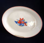 This oval serving platter is in the 1940s Calico Fruit design by Universal Potteries of Ohio. It measures 13-5/8" by 10-1/2" diameter. There are no chips, flakes, or cracks but the decal has...