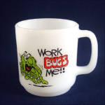 This vintage white milk glass Glasbake coffee mug has an illustration of a green monster running away in terror next to the words Work Bugs Me!! The back is marked  1982 C.M. Paula Co. PCM52, the bot...