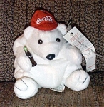 Small Coca Cola Polar Bear Bean Bag Plush, No. 0111, is wearing a Red Baseball with Coca Cola Logo. He is holding a bottle of Coca Cola in one paw. His tag is shaped like a Coca Cola bottle cap. A Coc...