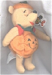 This Disney Pumpkin Pooh mini-bean bag 7-8 inches tall and he is wearing his Halloween costume of a smiling pumpkin suit with a green leaf-like collar, red sleeves; and he has pumpkin stem for hat. Th...