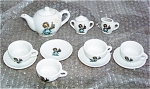 Child's Made In Japan China Tea Set from the 1950s or 1960s includes 4 child-sized cups and saucers, a creamer pitcher and sugar dish with lid, and a teapot with lid. Each of the main pieces of the te...
