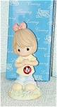 Precious Moments, Inc. 2005 The Art of Disney porcelain bisque figurine, 'You're My Mousketeer', is about 6 inches high. It represents a dark blonde girl with a pink with white dots hair bow and tear-...