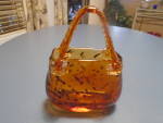 This is a ladies purse that is glass and a flower vase. Cute and mint and heavy. It is amber with brown/black flecks. It is in mint condition. A cute and different gift for that one who has everything...