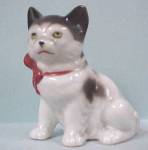 Sitting kitten with red bow, 3 7/8" high.  Japan, a little red cold paint wear, otherwise excellent.