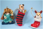 Dog Christmas Ornaments, excellent condition.  1985 Hallmark plastic terrier in stocking, 3 1/2" long.  Homco dog in boot, ceramic.  Other is resin. <BR>