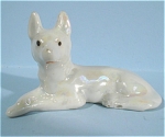 Miniature Japan Porcelain Lying German Shepherd, 1 1/2" high.  A couple of flaw bubbles at the end of the tail. 