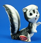 Japan Miniature Bone China Skunk, 1 7/8" high.  Has a yellow dot on top of head, otherwise excellent condition. 