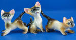 1950s Pottery Siamese Cat Trio, sitting 3 1/4" high, unmarked.  Glaze craze, otherwise excellent condition. 