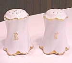 Offering this lovely set of salt and pepper shakers made of creamy white china, edged in gold - lettering is R & L.  Each measures 2 3/4 inches tall, marked R C on bottom (Philip Rosenthal & Co, AG/Ro...